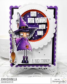 a card with an image of a witch holding a broom and wearing a purple hat