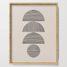 a black and white print on a beige wall above a wooden frame with an abstract design