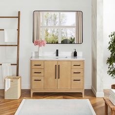 a bathroom with a wooden cabinet, mirror and rug on the floor in front of it