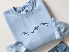 Embroidered Trio of Blue Whale Sweatshirt, Embroidered Blue Whale Shirt, Whale Shirt, Blue Whale Tshirt, Ocean Shirt Fish Shirt Marine Shirt, CozyGenZ This Embroidered Trio of Blue Whales Sweatshirt is a must have for ocean and whale lovers! Perfect for whale-watching. What's better than looking cute and warm with your favorite sealife in the colder month. Our crewnecks are made from the highest quality fabric for an incredibly soft and comfortable fit, with advanced printing and embroidery to e Blue Embroidered Crew T-shirt, Blue Embroidered Crew Neck Top, Light Blue Embroidered Tops With Crew Neck, Blue Embroidered Relaxed Fit T-shirt, Blue Embroidered Crew Sweatshirt, Blue Embroidered Crew Neck T-shirt, Whale Sweatshirt, Ocean Shirt, Blue Whales