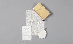 an assortment of personal items are displayed on a gray surface, including a passport and keychain