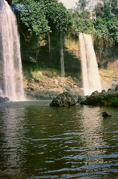 two large waterfalls in the middle of a body of water