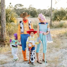 three people dressed up as toy story characters and one is holding a child's hand