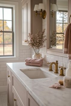 a bathroom with two sinks, mirrors and towels on the counter top next to each other