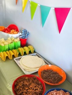 a table topped with plates and bowls filled with food