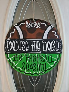 a football door hanger that says, excuse the noise it's football season