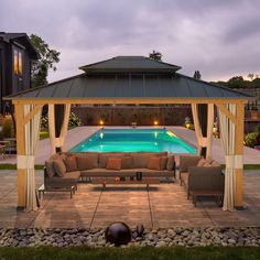 an outdoor living area with a pool and gazebo