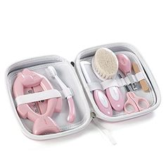 a pink and white case with scissors, combs and hairdryer in it