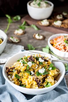 two bowls filled with food on top of a table