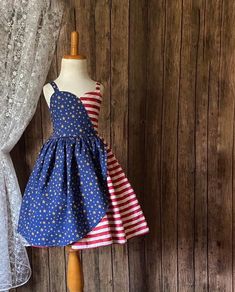 Your child can feel like a star. In their knee length patriotic dress ,made of 100% cotton, features a sweetheart bodice and elastic back for everyday comfort Sizing: Length is measured armpit to knee . See photos for sizing chart and how to measure.  Shipping :  Please allow 2-4 weeks   for this order to be shipped. All Items are shipped priority USPS mail. If you need it by a certain date, please check with me before making a purchase. I DO NOT DROP SHIP OR SHIP OUTSIDE OF THE USA  Photos:  Fa Patriotic Blue Dresses For 4th Of July, Blue Patriotic Cotton Dress, Patriotic Blue Cotton Dress, Blue Cotton Patriotic Dress, Red Patriotic Dress For 4th Of July, Patriotic Red Dresses For 4th Of July, Patriotic Blue Sleeveless Dress, Fitted Sleeveless Dress For 4th Of July, Patriotic Sleeveless Red Dress