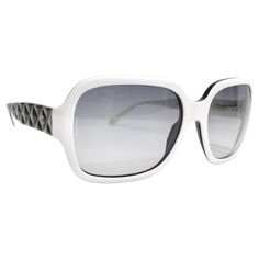 Introducing the Chanel Acetate Quilted CC Sunglasses, a stunning addition to your eyewear collection. This sophisticated pair features a striking white and black frame with large squared rims and grey-tinted lenses, offering a bold and fashionable look that seamlessly balances style and functionality. The unique design is elevated by the black faux quilted arms, reminiscent of Chanel's iconic quilted pattern, adding texture and depth to the overall aesthetic. A small gold tone Chanel CC logo sub Chanel Eyeglasses 2022, Elegant Optic White Sunglasses With Tinted Lenses, Chic White Square Frame Sunglasses, Elegant Optic White Polarized Sunglasses, Elegant White Sunglasses With Uv Protection, Designer White Polarized Sunglasses, Designer White Sunglasses With Polarized Lenses, Elegant White Square Frame Sunglasses, White Acetate Sunglasses For Summer