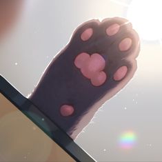 an animal's paw with pink spots on it