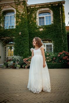 This gorgeous dress features a very elegant, yet simple, style!  The dress is completely lined and adorned with lace. Back elastic and bow for ease and comfort!  A full tulle skirt with gown length. The ivory color adds a bit of vintage charm. This gown is fully lined in 100% cotton for a comfortable feel. We know that tulle can be scratchy, and kids don't like scratchy dresses! We're here to provide you with the perfect combination of elegance and comfort for your next formal occasion. This gown is stunning for flower girls, junior bridesmaids, baptisms, dedications, portraits, blessing ceremonies, and much more! DELIVERY Dresses are made to order, so they will be ready for delivery within 5-7 working days (or less). In each case, I will tell you the exact date of readiness for delivery. First Communion Gown With Tulle Skirt, Princess Style First Communion Ball Gown With Lace Bodice, Lace Princess Dress For Confirmation, White Princess Dress With Lace Trim For Bridesmaids, Lace Princess Dress For Confirmation, Ball Gown Style, Confirmation Lace Princess Dress Ball Gown, Lace Ball Gown For First Communion, First Communion Princess Dress With Lace Bodice, First Communion Lace Ball Gown With Tulle Skirt