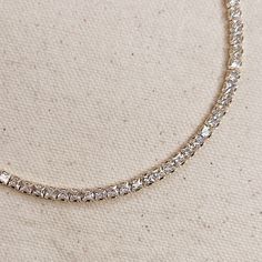 Adorn your neck with this stunning 18k gold-filled Tennis necklace. Delicate and minimalist, its classic look is sure to make a statement. 3mm Metal: 18k Gold Filled Measures 12 inches long + 4 inches extender chain Tarnish Resistant Yellow Gold Cubic Zirconia Chain Necklace, Everyday Cubic Zirconia Necklaces, Everyday Cubic Zirconia Necklace, Everyday Luxury Sterling Silver Tarnish-resistant Necklace, Gold Cubic Zirconia Diamond Necklace Tarnish Resistant, Gold Delicate Chain Necklace With Cubic Zirconia, Elegant Gold-tone Tarnish Resistant Necklaces, Elegant Gold-tone Tarnish Resistant Necklace, Gold Clavicle Chain Diamond Necklace