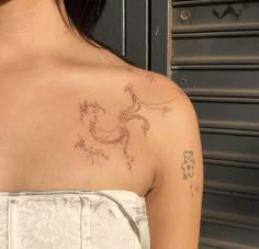 a woman with a tattoo on her shoulder