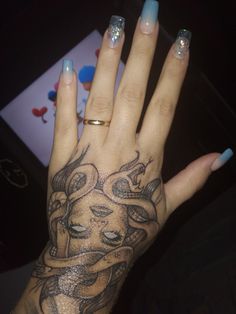 a woman's hand with a tattoo on it