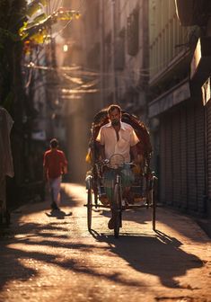 a man riding on the back of a horse drawn carriage down a street