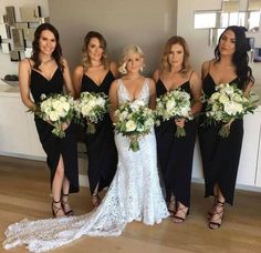 the bridesmaids are all dressed in black dresses and holding their bridal bouquets