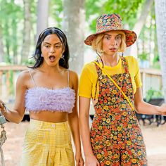 two women in matching outfits standing next to each other and making funny faces with their mouths open