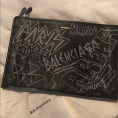 Balenciaga Graffiti Clutch Balenciaga Clutch, Bags Balenciaga, Gucci Pouch, Valentino Sneakers, Black Clutch Bags, Floral Clutches, Black Leather Clutch, Balenciaga Black, Leather Floral