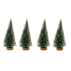 three small christmas trees sitting next to each other