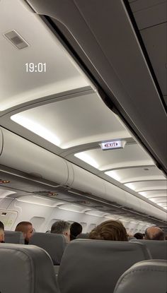 the inside of an airplane with people sitting in it