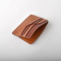 This wallet is made using top grain cowhide, featuring contrasted smooth and textured leathers for each card slot. The wallet features 4 card slots on either side and a interior pouch for bills. Made in CanadaGenuine Cowhide Leather Leather Trifold Card Holder With Leather Lining, Cognac Leather Wallet With Rfid Blocking, Leather Wallets With Card Slots For Business, Cognac Leather Wallet With Smooth Grain, Leather Wallets With Interior Card Slots In Cognac, Cognac Bifold Wallet With Smooth Grain, Classic Cognac Wallet With Smooth Grain, Cognac Leather Wallets With Interior Card Slots, Cognac Leather Card Holder With Interior Slots