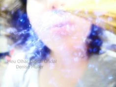 a blurry photo of a woman's face with blue hair