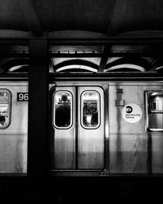 two silver subway cars sitting next to each other