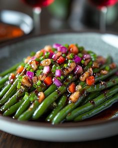 a white plate topped with green beans and red onions