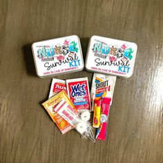 three small tins filled with candy and toothpaste on top of a wooden table