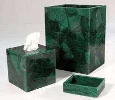 three pieces of green marble with one tissue dispenser and the other container