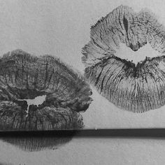 a pencil drawing of two lips on paper