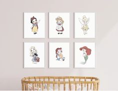 four disney princesses are hanging on the wall next to a baby's crib