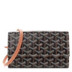 This is an authentic GOYARD Goyardine Varenne Continental Wallet in Black and Gold. This shoulder bag is crafted of coated canvas with the classic Goyard chevron monogram in black and brown. It features a removable strap and silver hardware. The flap opens to a brown interior with card slots, pockets, and a zipper compartment. Brown Interior, Silver Hardware, Black And Gold, Continental Wallet, Card Slots, Slots, Black And Brown, Monogram, Wallet