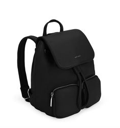 TATUM Black Vegan Backpack by sustainable brand Matt & Nat. Backpack with drawstring and flap closure, padded adjustable straps, top handle, and 2 front zippered pockets. Interior: Zipper pocket, smartphone pocket, and logo-embossed Sol patch. Dimensions: 9"L x 11.5" x 6" Handle Drop: 3.5" Adjustable Shoulder Strap: 24.5” - 30" The outer body and lining of the Sol Collection are made from recycled materials. All of the interior linings of our bags are made from 100% recycled plastic bottles. Our Travel Backpack With Removable Pouch And Flap, Modern Backpack With Detachable Strap And Flap, Eco Backpack, Tech Bag, Vegan Leather Backpack, Work Tote Bag, Matt & Nat, Shoe Boutique, Back Jewelry