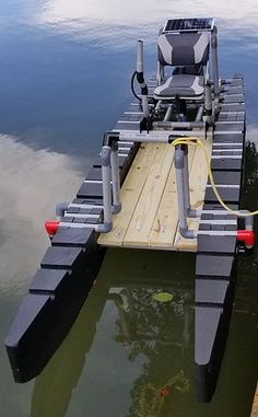 a small boat is tied up to the dock with its motor on it's side