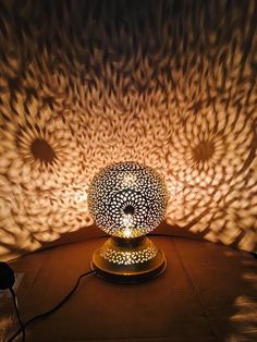 a lamp that is sitting on top of a table with the light shining through it