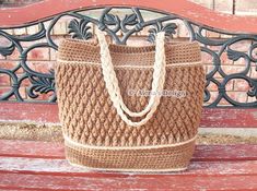 a brown bag sitting on top of a wooden bench