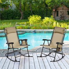 two lawn chairs sitting next to a swimming pool