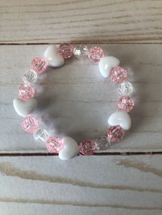 This is a Valentine Heart Bracelet. It would make a cute gift for a little girl for Valentines Day. It would make a cute gift for a little girl's Birthday. It has five heart beads. It has pink and clear 8mm faceted beads. It was made with.8mm sturdy stretch string. It fits girls ages 5-8. It stretches to fit on the wrist. All items are ready to be shipped I do combined shipping. Items ship in 2-5 business days. Check out more items at: http://www.etsy.com/shop/MesheleCrafts  https://www.facebook Bracelets Kids, Valentines Bracelets, Bracelet Heart, Kids Bracelets, Bracelet Beaded, Heart Beads, Plastic Beads, Valentine Heart, Cute Gift