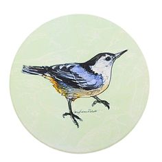 a small bird painted on a green plate