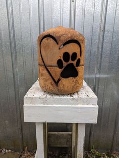 a wooden block with a dog's paw and heart on it sitting on top of a table