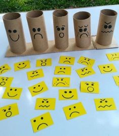 several rolls of toilet paper with faces drawn on them sitting on a table next to each other