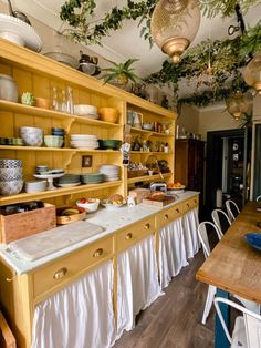 a kitchen filled with lots of wooden shelves