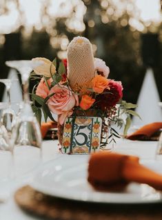 the table is set with flowers and place settings for an elegant dinner or reception party