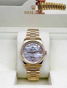 Style Number: 118238 Serial: D96*** Year: 2005   Model: President Day Date   Case Material: 18K Yellow Gold   Band: 18K Yellow Gold   Bezel: 18K Yellow Gold   Dial: Original Factory MOP Diamond Dial   Face: Sapphire Crystal   Case Size: 36mm   Includes:  -Rolex Box -Certified Appraisal  -1 Year Warranty SKU 21414 / 152830TJD071624   Return Policy: Returns accepted up to 14 days. No returns on watches stated as brand new or vintage.  Shipping:  We use Fedex priority overnight, fully insured with signature required upon delivery.    International Buyers:  Buyer is responsible for any customs fees or duties incurred by their country based on their country's rules & regulation no exceptions! We do not declare items of a lower value or mark any items as gift.  Feedbacks: We strive to provide ou Gold Rolex, Presidents Day, Rolex Day Date, Pearl Diamond, Gold Band, Sapphire Crystal, Gold Bands, Accessories Watches, Mother Of Pearl