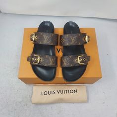 Louis Vuitton Brown Buckle Bom Dia Monogram Flat Slide Sandal Size Eu 37 Us 7 Womens Comes Box And Dustbag 100% Authentic *Price Is Firm* Color: Cacao Brown Classic Dark Brown Slip On Sandal With Allover Lv Monogram Print Patent Monogram Canvas Adjustable Strap Anatomic Insole Smooth Outsole Louis Vuitton-Engraved Buckle Please Note Signs Of Wear On Bottom As Shown. Luxury Slides With Buckle Closure, Luxury Brown Slides, Luxury Brown Slides With Round Toe, Luxury Brown Sandals With Round Toe, Louis Vuitton Brown, Lv Monogram, Monogram Prints, Louis Vuitton Shoes, Monogram Canvas