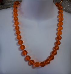 "Vintage c1950's tangerine orange clear lucite bead necklace Excellent condition 1/2\" diameter bead, except for the bead adjacent to the clasp bead, those are 3/8\" diameter and 1/4\" diameter The clasp bead is 1/2\" 26 inches long" Luxury Orange Hand-strung Beaded Necklace, Orange Costume Jewelry Beaded Necklace, Classic Orange Round Necklace, Orange Single Strand Beaded Necklace, Orange Beaded Round Necklace, Orange Single Strand Beaded Necklace With Round Beads, Orange Large Beads, Formal Orange Single Strand Necklace, Vintage Orange Round Beads Necklace