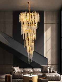 a chandelier hanging from the ceiling in a living room next to a couch